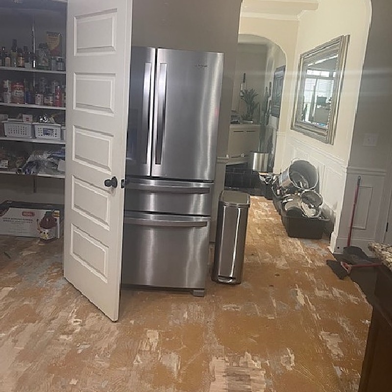 Kitchen floor stripped to subfloor during water damage mitigation in a Georgia home