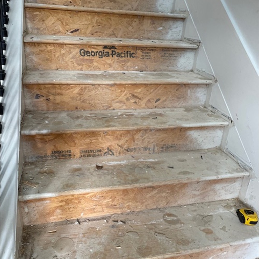 Staircase stripped to subfloor during water damage mitigation in a Georgia home