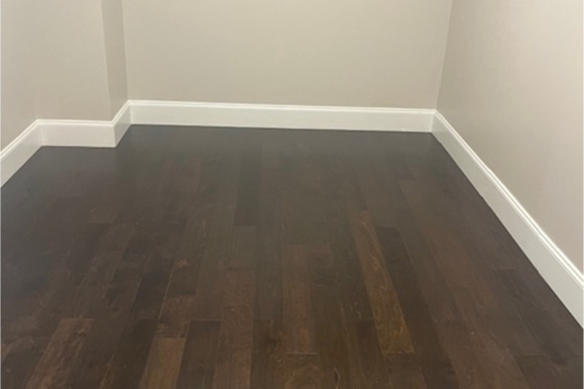 Master closet with new hardwood after water damage restoration