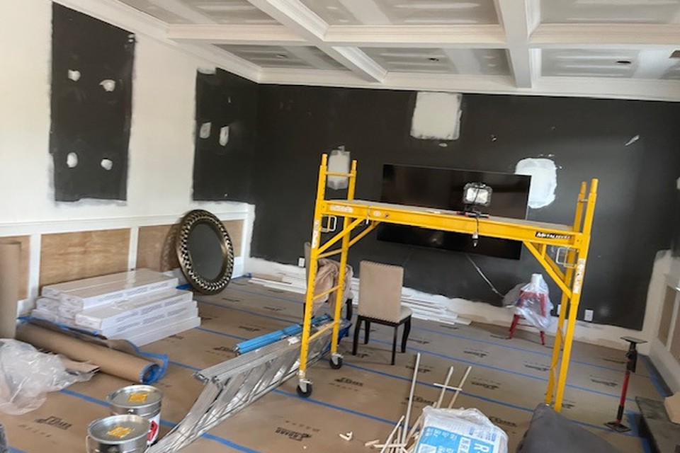 Living room ceiling opened and reframed during water damage restoration in a Georgia home