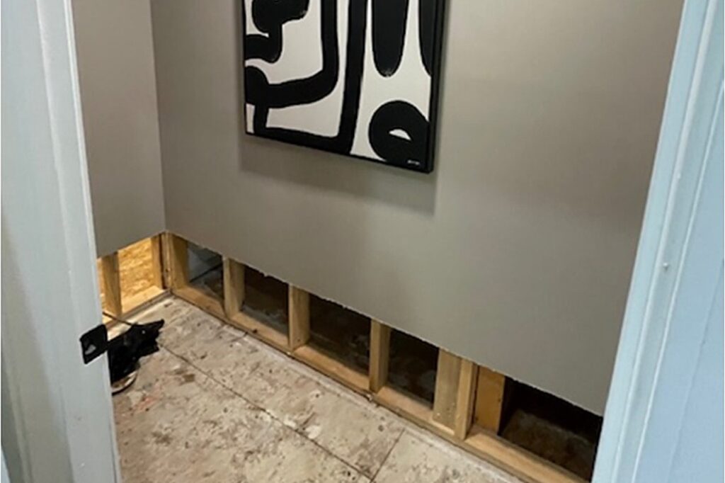 Flood cuts and exposed studs in the master suite where the water release began