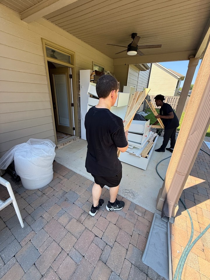 Crew carrying furniture out during a contents pack-out in metro Atlanta