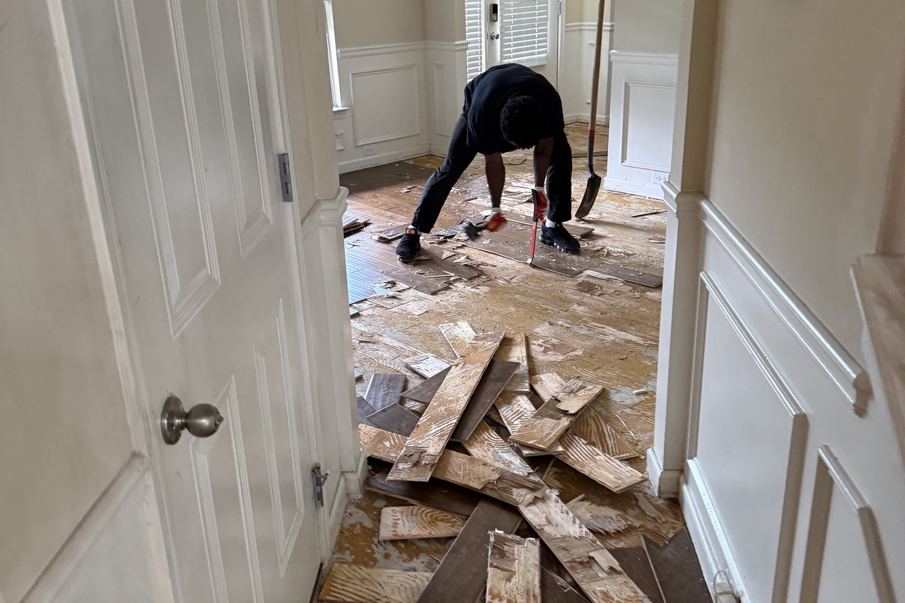 Water-damaged hardwood being removed from a Gwinnett County foyer