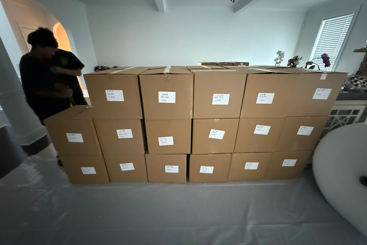 Labeled pack-out boxes staged on floor protection in a Gwinnett County home